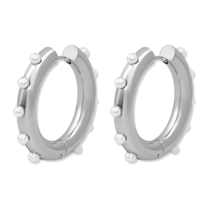 Detailed view of silver hoop earrings with white pearls and snap closure mechanism