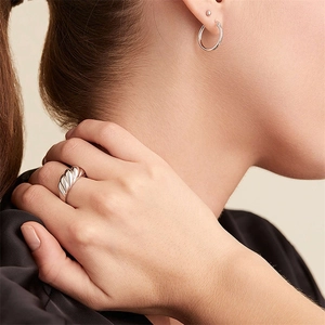 Polished silver croissant ring and hoop earrings set worn by a fashion model