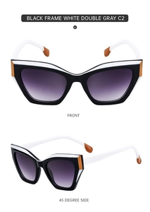 Cat eye sunglasses detail with black and white frame and gradient grey lenses
