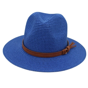 Detail of royal blue woven straw fedora hat with brown leather belt and tassel accent