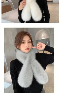 Detail of white and grey faux fur scarf showing cross-hole design and soft texture