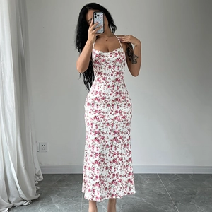 Detail of slim fit white floral maxi dress with spaghetti straps and a side leg slit
