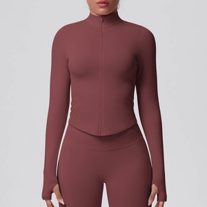 Detail of seamless thumbhole cuffs and zip collar on a dark red yoga jacket