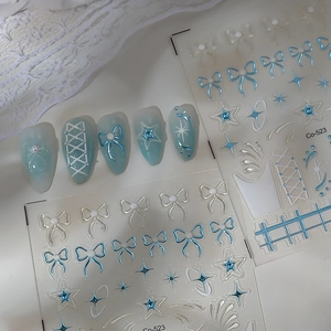 Detailed view of Co-523 nail art stickers with 3D ice blue bows and star patterns