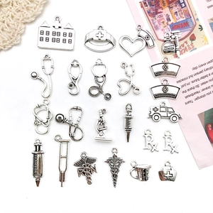 Set of 20 silver medical themed charms including stethoscope syringe and RN icons