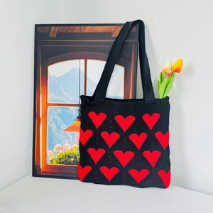 Knitted heart pattern tote bag in black and red with elegant tulip floral accents