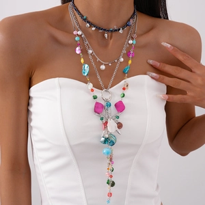 Close-up of bohemian multilayer necklace with faux pearls, shells, and turquoise charms