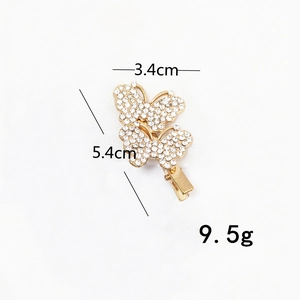 Detail view of butterfly rhinestone clip showing dimensions 3.4cm by 5.4cm and 9.5g weight