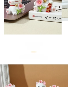 Detail of cute cherry blossom lucky cat figurine holding peace scroll on a desk