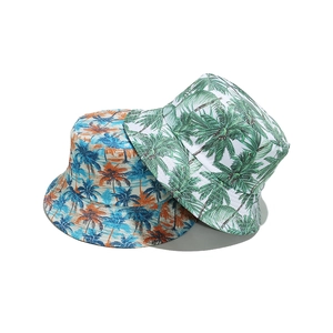 Tropical coconut tree print bucket hats in orange and green for summer beach vacations