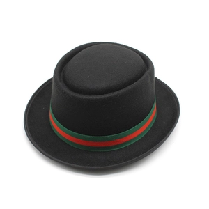 Detail of black wool pork pie hat featuring signature green and red striped ribbon band