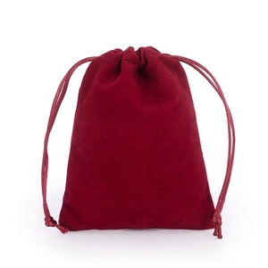 Macro shot of red velvet drawstring pouch for jewelry storage with premium texture
