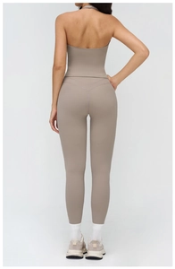 Detail view of the V-shaped waistband and flatlock stitching on yoga leggings
