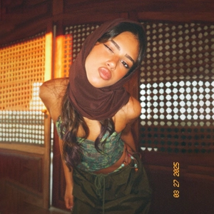 Detail view of retro floral crop top and military green pants with film aesthetic vibe