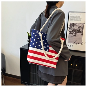 Detail of canvas tote bag with thick rope handles and American flag star print