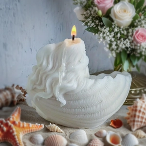 Gros plan d'une bougie parfumée en forme de coquillage avec étoile de mer et décor marin