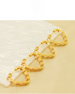 Detail of 18K gold plated heart earrings with zircon, nickel-free and eco-friendly