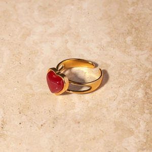 18k gold stainless steel open ring with heart-shaped red agate on marble surface