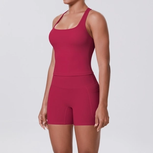 Detail of dark red yoga set showing racerback tank top and shorts with side pockets