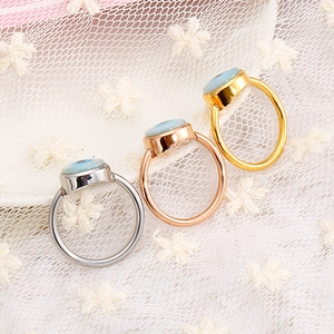 Three evil eye rings in silver, gold and rose gold finish on white lace fabric