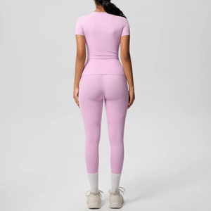 Back view of a slim-fit pink yoga set with short-sleeve top and high-waist leggings