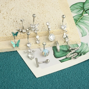 Detailed selection of zircon heart, butterfly and snake belly rings on stone background