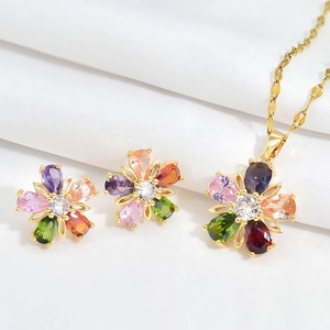 Detail of flower-shaped jewelry set with colorful pear-cut stones and golden finish