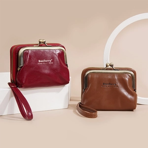 Close-up of litchi pattern coin purses in burgundy and brown with wristlet straps