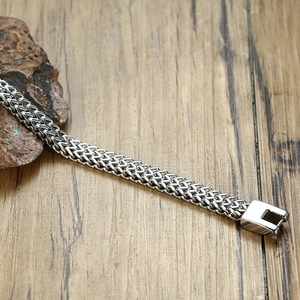 Hip-hop style silver stainless steel dragon bone chain bracelet on a rustic wood background