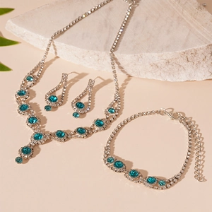 Detailed view of luxury peacock blue crystal jewelry set on white natural stone