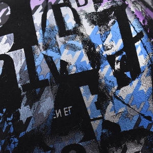 Macro view of twill fabric with street style graffiti print in purple and blue tones