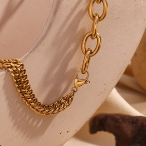 Detailed close-up of 18K gold plated double Cuban and oval link chain with lobster clasp