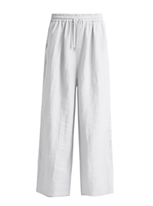Detail of white cotton linen trousers featuring elastic waistband and adjustable drawstring