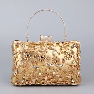 Detail of evening clutch with gold rhinestones and floral metal cutout patterns