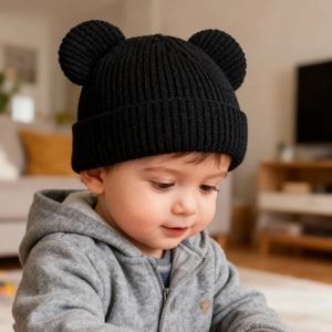 Close-up of black baby knit hat with cute bear ears and soft vertical ribbed texture