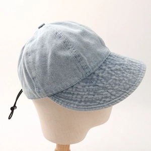 Detail of light blue denim baseball cap with adjustable drawstring and stitching