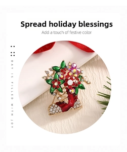 Detail view of festive Christmas boot brooch with red and green enamel and sparkling rhinestones