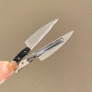 Detailed close-up of creative chef knife hairpins with realistic metallic finishes