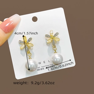 Macro view of gold flower earrings with pearls and crystals on S925 silver needles
