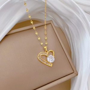 Titanium steel heart pendant necklace with gold plating and cubic zirconia on silk