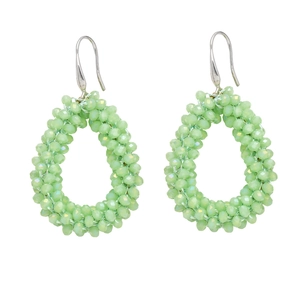 Detail of bohemian mint green teardrop beaded earrings with multifaceted texture and silver hooks