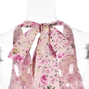 Detail of pink floral halter top featuring a back lace-up tie and elegant bow design