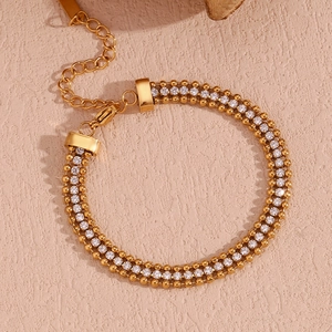 Close-up of 18K gold-plated braided chain bracelet with white zircons and lobster clasp