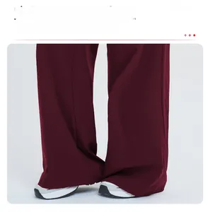 Detail of loose wine red sun protection pants with wide-leg cut and flowy fabric texture