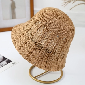 Breathable hollow woven straw bucket hat in natural brown for summer sun protection