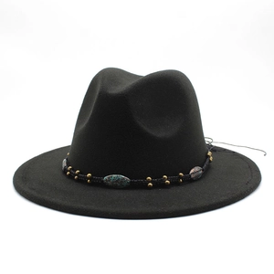 Detail of black wool fedora with woven band featuring gold beads and turquoise stones