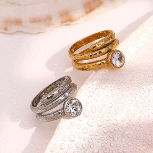 Detail of 18K gold and silver double-layered snake head rings with crystals and water drops
