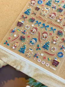 Detailed macro view of 3D embossed Christmas bear and tree nail art stickers YT3987
