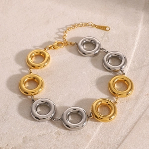 Detailed view of two-tone gold and silver circular link bracelet with adjustable lobster clasp