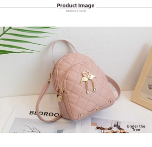 Close-up of pink quilted mini backpack featuring gold twin swan charm and metal rivets
